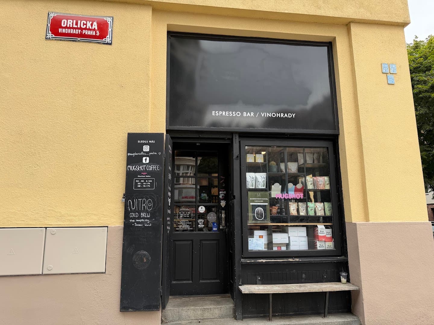 Storefront of Mugshot Coffee, specialty coffee shop in Prague