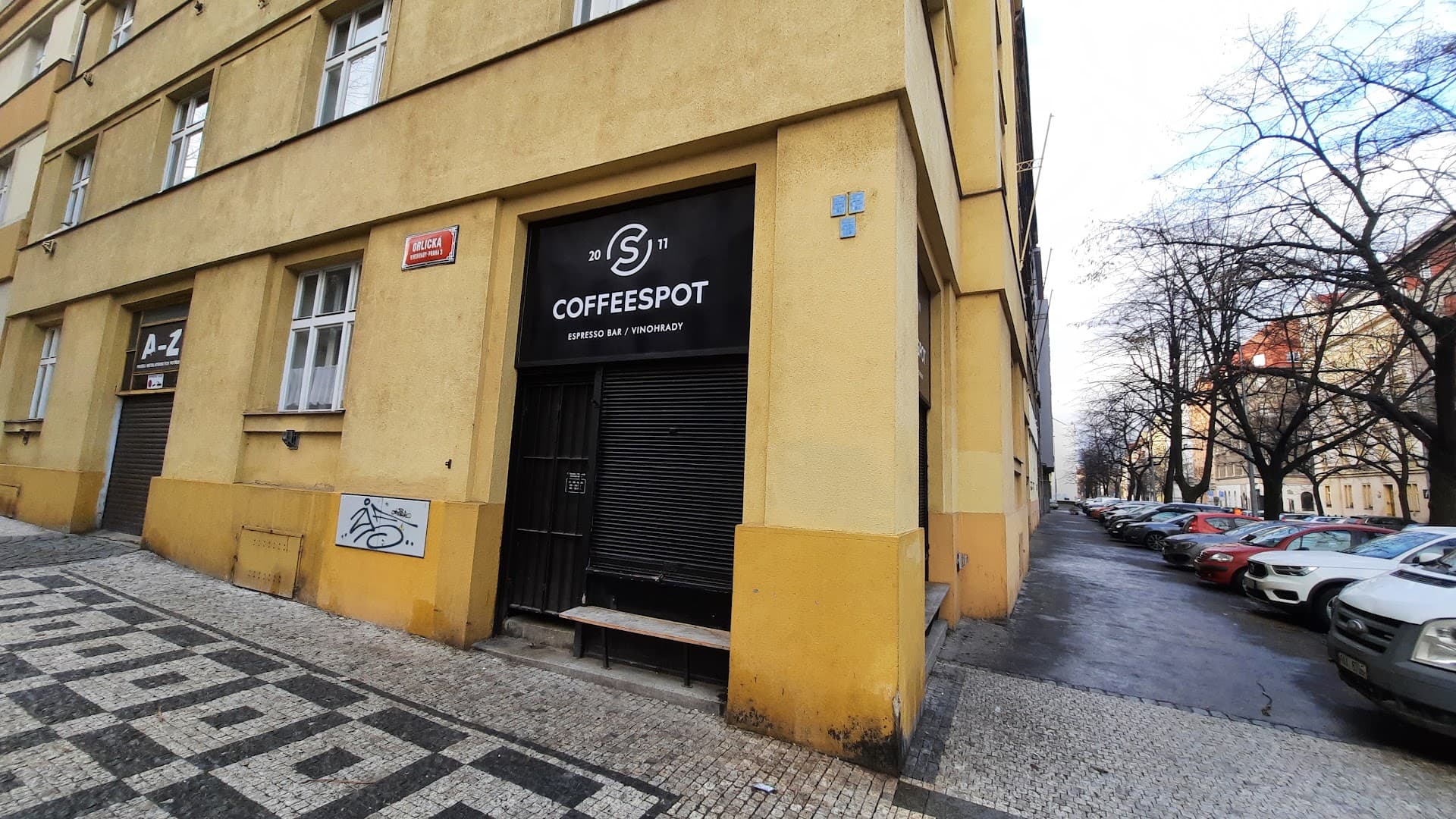 Storefront of Mugshot Coffee, specialty coffee shop in Prague