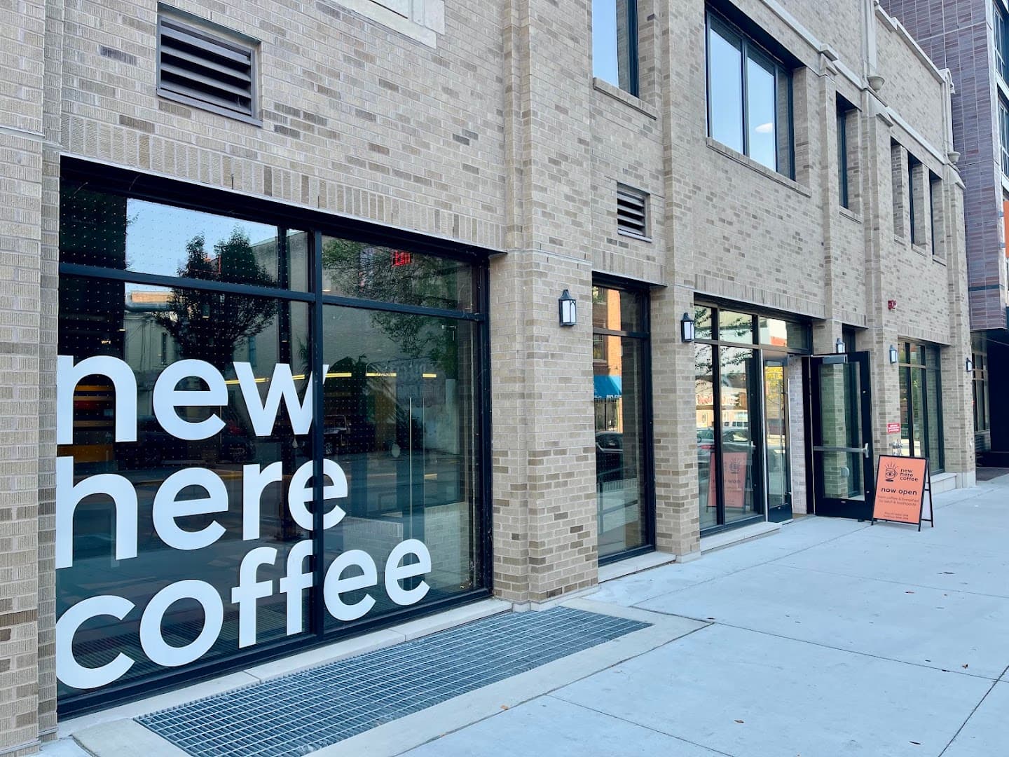 Storefront of New Here Coffee, specialty coffee shop in Madison